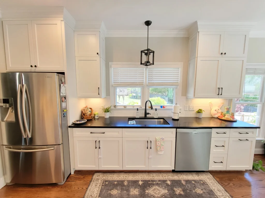 Kitchen cabinetry showing painted door fronts and wood grain