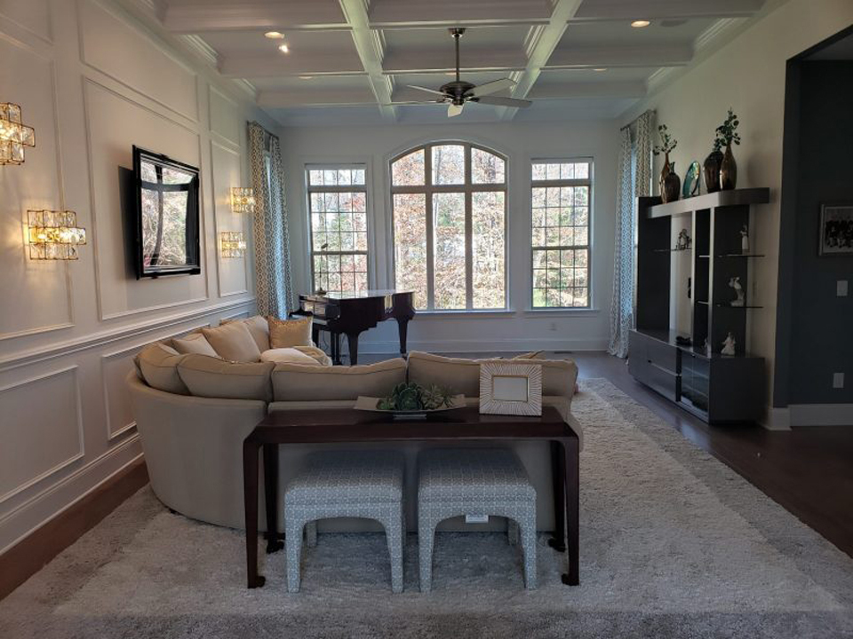 Converted attic space finished as a bright living room with new flooring and trim