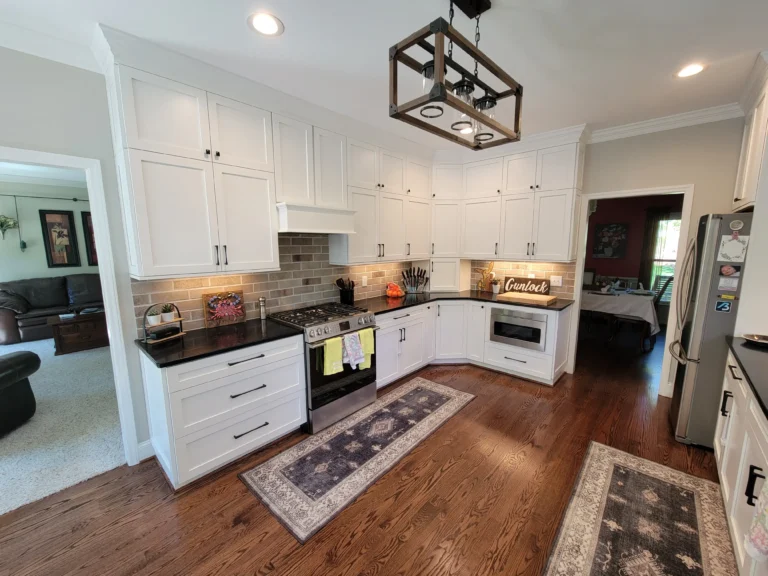 Remodeled kitchen with white shaker cabinetry and a tiled backsplash